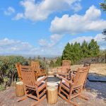 Sunlit dining nook with wooden table and chairs overlooking San Jose hills.
