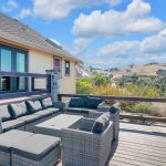 Outdoor lounge deck with sectional couch seating and panoramic valley backdrop in San Jose.
