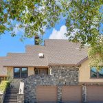 Exterior front of luxury 5-bedroom home in San Jose CA with stone facade and multi-car garage.