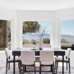 Modern formal dining table set near windows with panoramic views of San Jose CA.