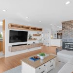 Living room TV area with open view into kitchen in modern 5-bedroom San Jose home.