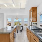 Gourmet chef kitchen with custom wood cabinetry and center island in San Jose luxury home.