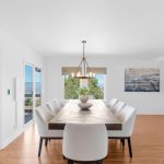 Modern dining room with large table and pendant lighting in luxury 5-bedroom San Jose estate.