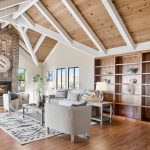 Open concept great room featuring hardwood floors and high wooden beam ceilings in San Jose home.