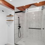 Walk-in glass shower enclosure with modern black fixtures and subway tile in San Jose bath.
