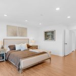 Staged primary bedroom with large bed and neutral decor in San Jose 5-bedroom home.