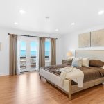 Bedroom with glass French doors leading out to private balcony with views in San Jose.