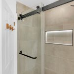 Modern walk-in tile shower with frameless glass sliding door in San Jose bath.