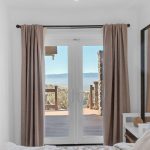 Spacious guest bedroom with neutral linens and natural sunlight in San Jose property.