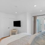 Bedroom french doors opening to deck with panoramic valley views in San Jose, CA.