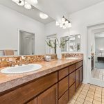 Bathroom at 646 Luna Park Drive featuring a long vanity with dual sinks and large mirror