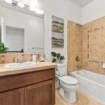 Full bathroom at 646 Luna Park Drive with bathtub shower combination and tile surround