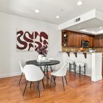 Dining area overlooking living room with private balcony access