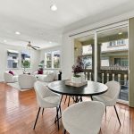 Open-concept dining, kitchen and living areas with hardwood floors