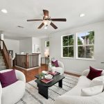 Bright living room with hardwood floors and multiple windows