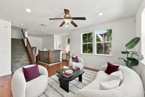 Bright living room with hardwood floors and multiple windows