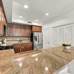 Open kitchen with granite counters and stainless steel appliances