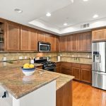 Kitchen with wood cabinetry, granite counters and stainless steel appliances