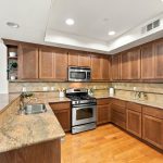 Kitchen with granite counter overlooking the living room