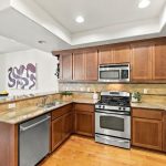 Wood cabinetry, granite countertops and stainless steel kitchen appliances